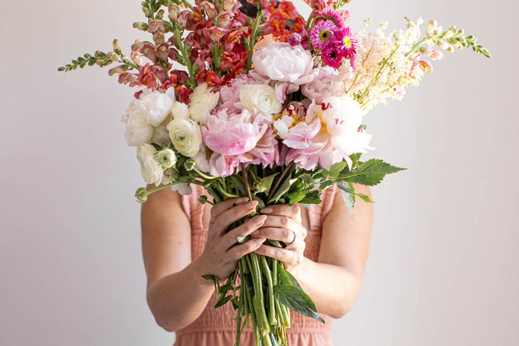 Creative Outlet 1 - Woman Holding Pink Flowers