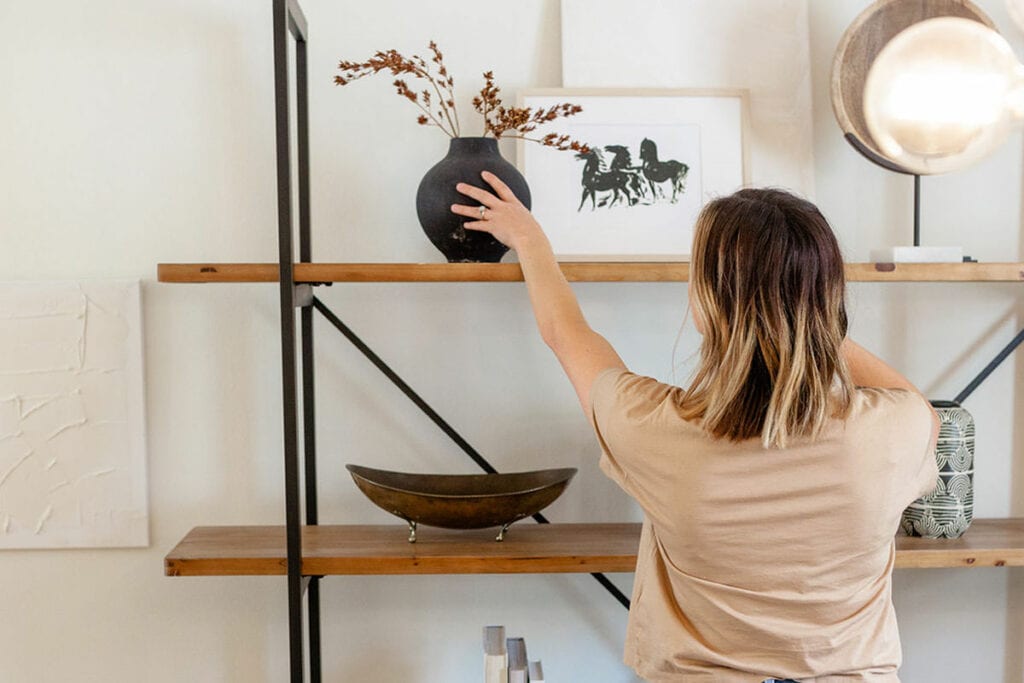 Creative Outlet 5 - Woman decorating wooden shelves