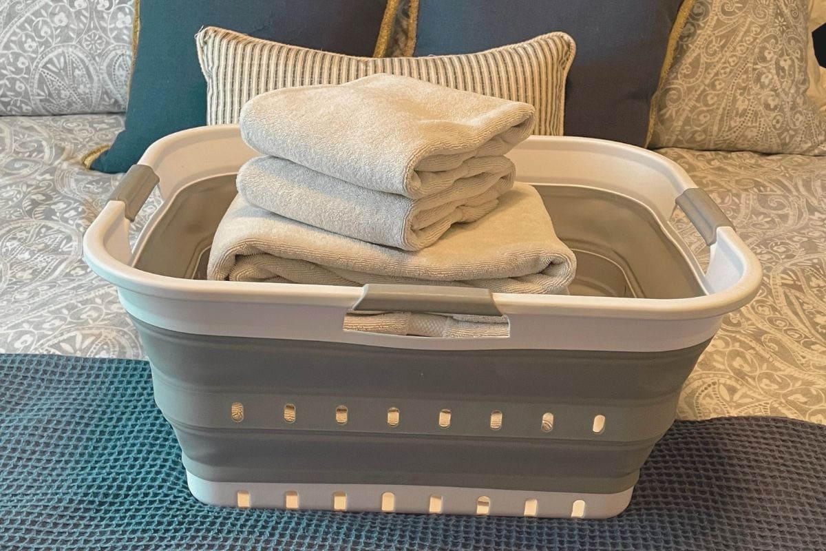 Laundry Essentials 1 - Laundry basket filled with folded towels