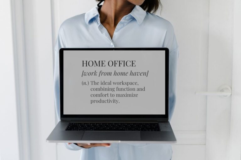 Woman holding laptop with "home office" definition