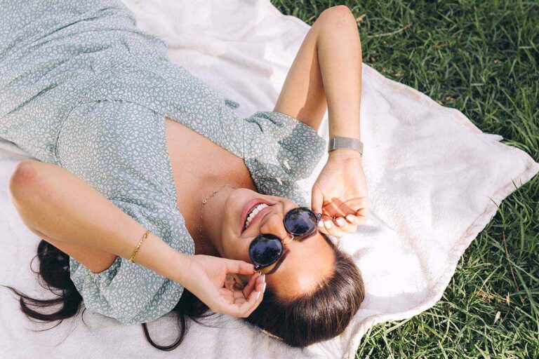 Time for a Change 1 | Smiling girl lying on blanket in grass