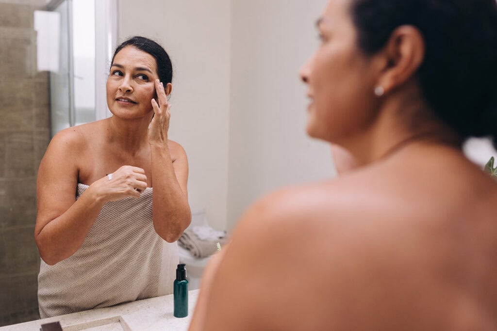 Middle-aged women looking in mirror
